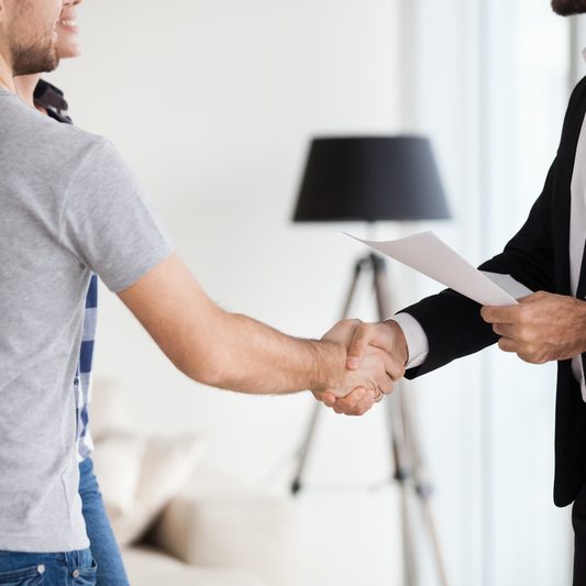 Young couple, family at meeting making deal, signing ontract