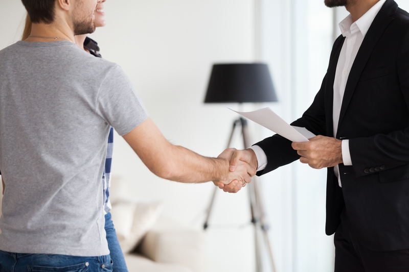 Young couple, family at meeting making deal, signing ontract Young couple, family at meeting making deal, signing ontract